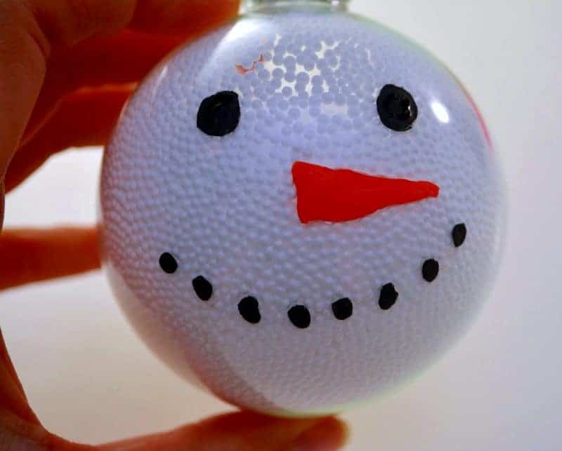 This handmade snowman Christmas ornament is fun and easy for the kids to make using clear plastic ball fillable ornaments.