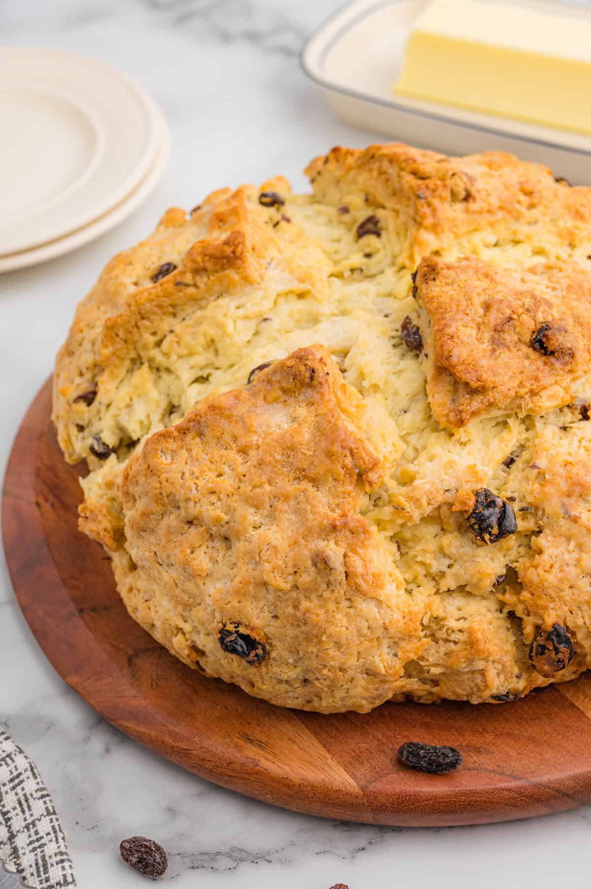 Rustic Irish soda bread loaf with raisins and caraway seeds, sliced for serving