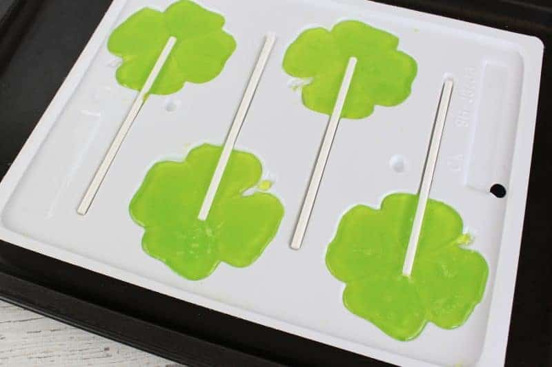 Green shamrock Jolly Rancher lollipops will make the perfect treat for your St. Patrick's Day party. They are as easy to make as crushing the candies, placing them in the mold, and popping them in the oven!