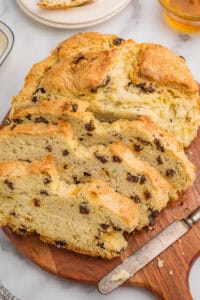 Sliced Irish soda bread with raisins on a wooden board