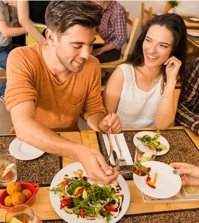 Man and woman eating at a restaurant