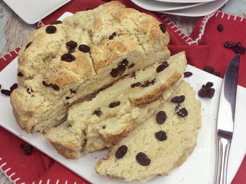 You will love this quick and easy Irish Soda Bread with Raisins recipe made with flour, baking soda, salt, sugar, egg, butter, buttermilk, and raisins for St. Patrick's Day or any time of year!