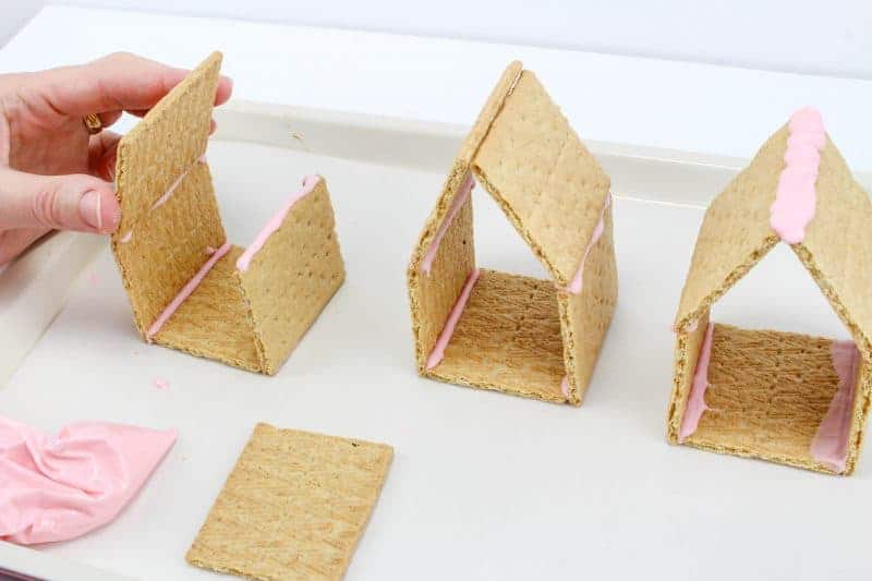 Peeps chicks houses are a fun no bake Easter treat perfect for the kids this Spring season. Made using Peeps Chicks, graham crackers, egg candies, and edible grass, this cute Easter recipe is perfect to make with the little ones.