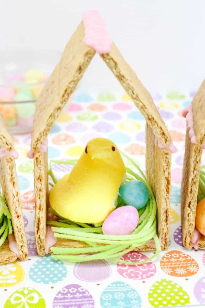 Peeps chicks houses made using Peeps Chicks, graham crackers, egg candies, and edible grass.