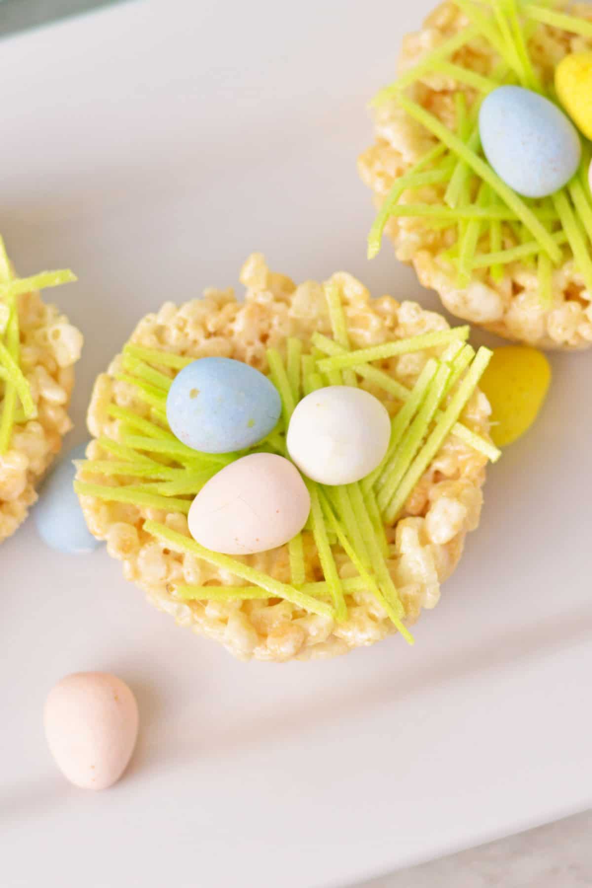 Overhead view of Rice cereal treat filled with cadbury mini eggs and green edible grass.