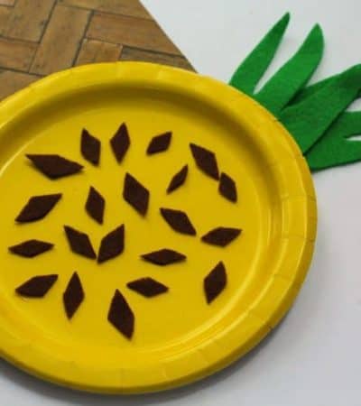 A fun and easy summer craft for kids perfect for home or school. This paper plate pineapple craft is colorful, fun, and easy to make using craft felt or paper, a paper plate, and glue.