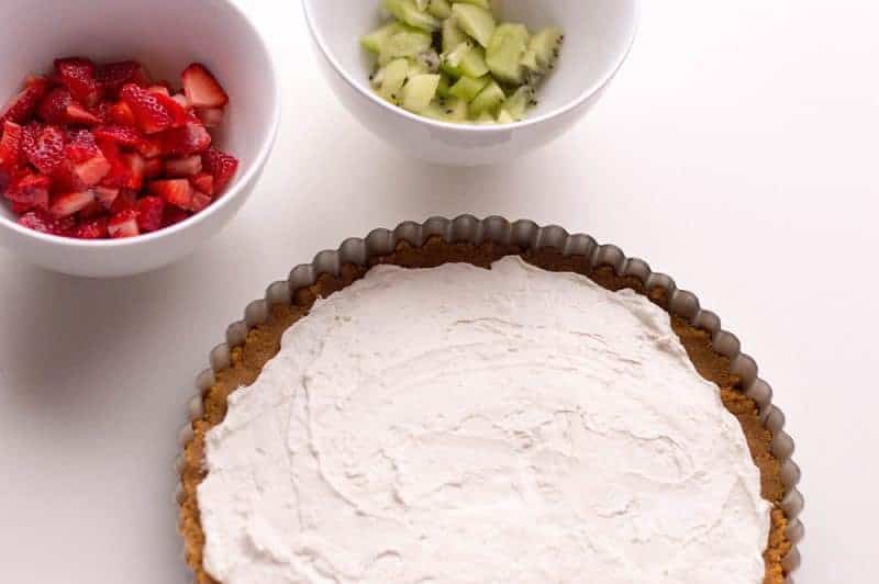 With cream cheese and fresh fruit on top of a homemade graham cracker crust, this no-bake fruit pizza recipe makes a perfect summer dessert. 