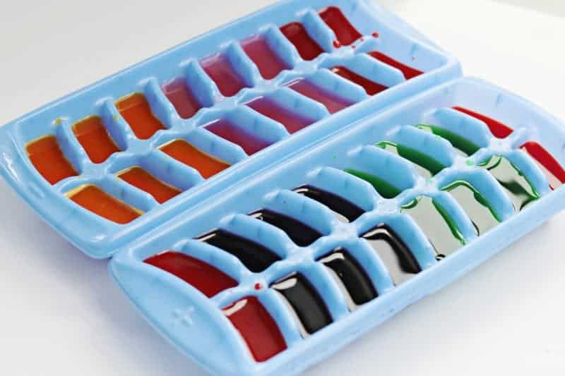 This colored ice play activity using ice cubes colored with drink mix makes for a  fun, low cost, and easy outdoor sensory activity for little ones.