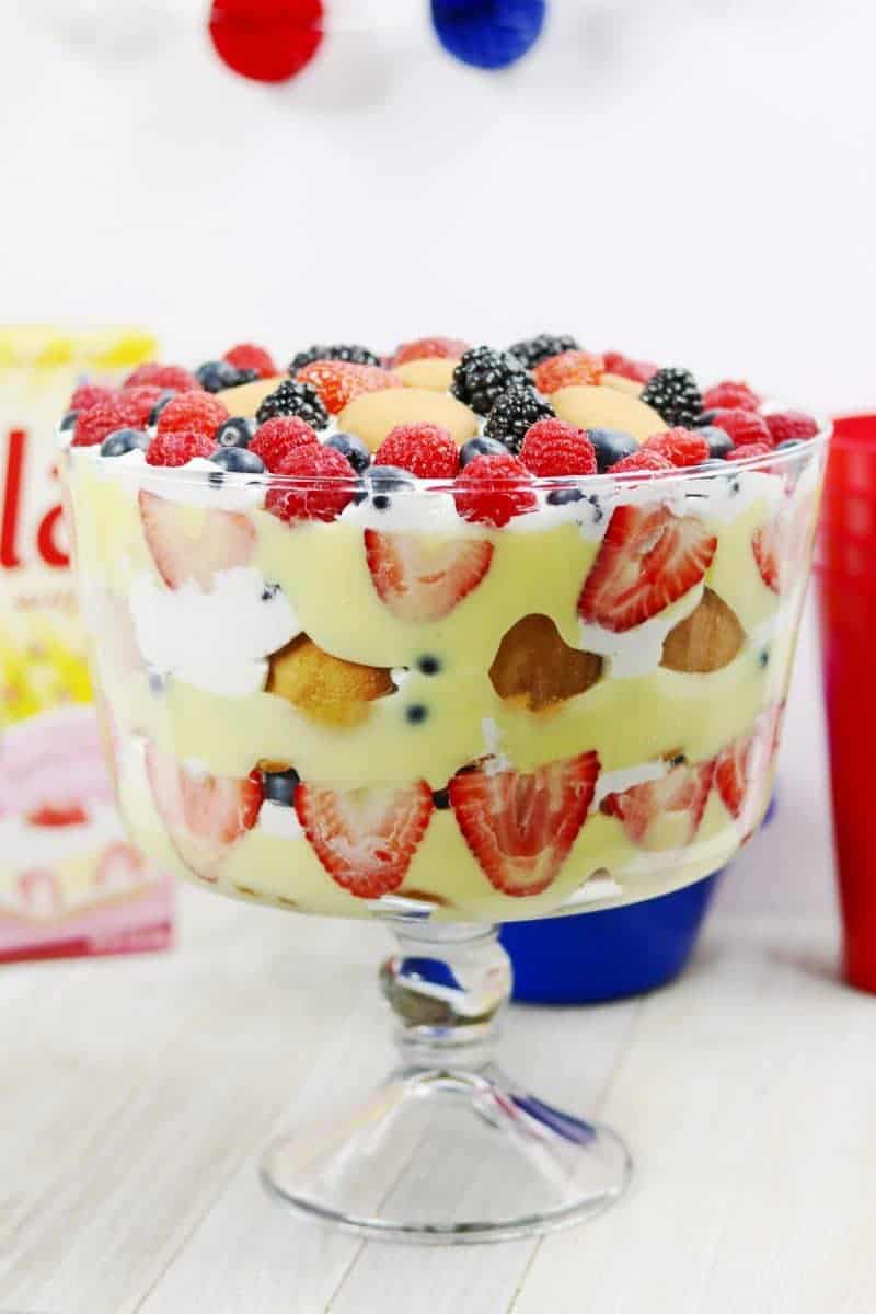 A red, white, and blue patriotic berry trifle recipe made with fresh berries, Nilla Wafers, vanilla pudding, and frozen whipped topping. This easy trifle recipe makes a great no-bake summer dessert and is perfect for patriotic holidays such as Memorial Day, 4th of July, and Flag Day.