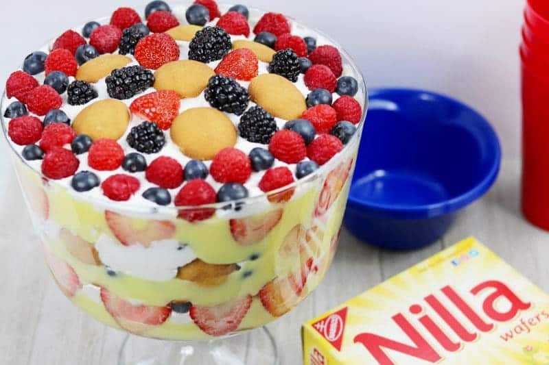 A red, white, and blue patriotic berry trifle recipe made with fresh berries, Nilla Wafers, vanilla pudding, and frozen whipped topping. This easy trifle recipe makes a great no-bake summer dessert and is perfect for patriotic holidays such as Memorial Day, 4th of July, and Flag Day.
