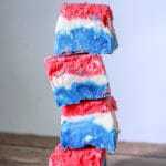 A red, white, and blue marshmallow creme fudge recipe made with marshmallow creme, evaporated milk, white chocolate chips, sugar, butter, and food coloring.