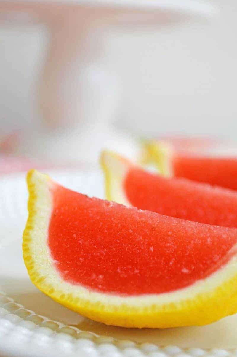 Strawberry lemonade jello shots made with vodka and served in lemon wedges. Don't be fooled -- these lemon wedge jello shots are actually very easy to make!