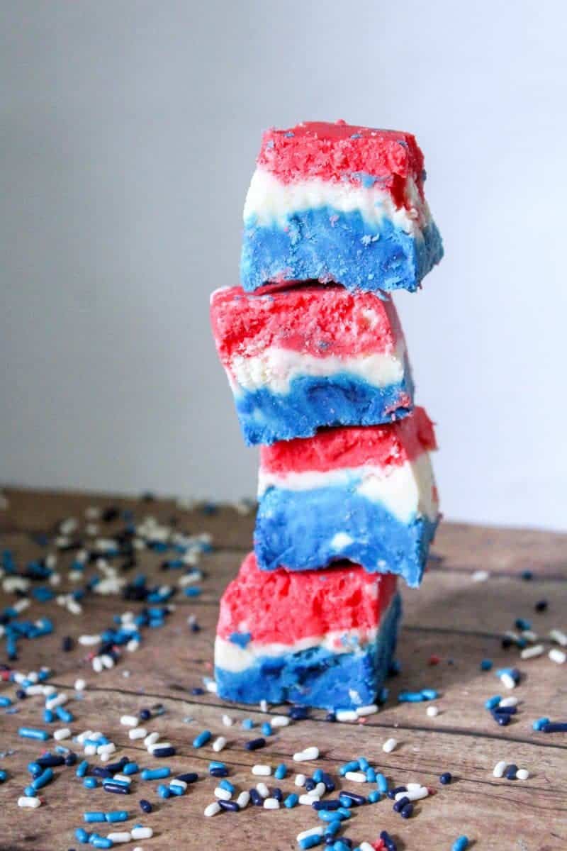 A red, white, and blue marshmallow creme fudge recipe made with marshmallow creme, evaporated milk, white chocolate chips, sugar, butter, and food coloring.