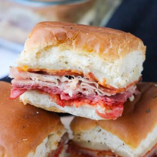 Hot Italian sliders on Hawaiian rolls with Italian meats. melty cheese, and marinara sauce.