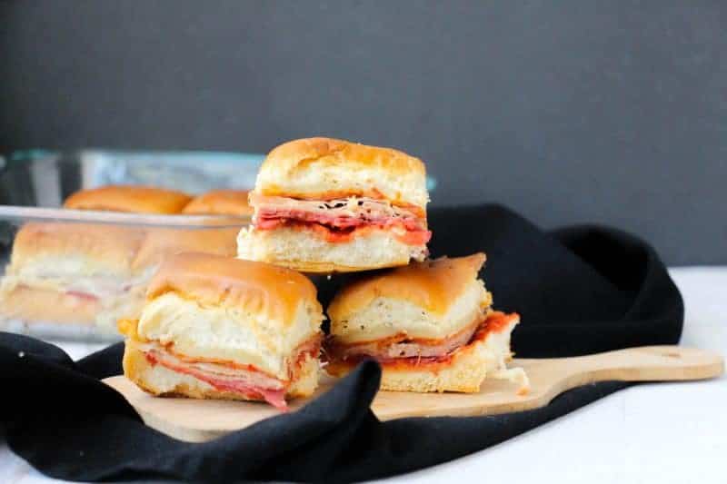 Italian sliders on Hawaiian rolls packed with salami, pepperoni, prosciutto, mozzarella cheese and tomato sauce.