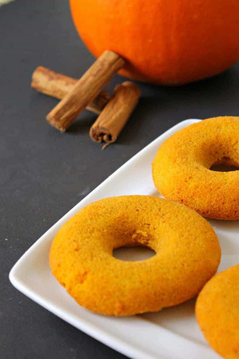 Baked pumpkin doughnuts served warm and smothered with glaze are the perfect Fall recipe for breakfast and dessert alike.