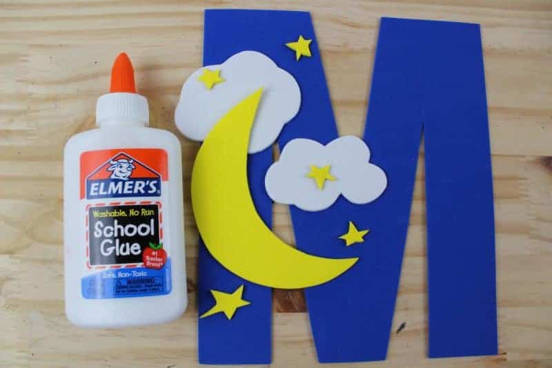 Glue the moon and the clouds on to the letter M