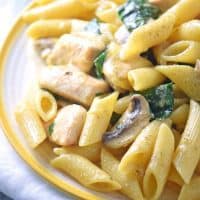 This creamy one-pot chicken pasta recipe takes just 30 minutes to cook. With spinach, mushrooms, and a creamy sauce, everyone in the family will love this easy one-pot meal.