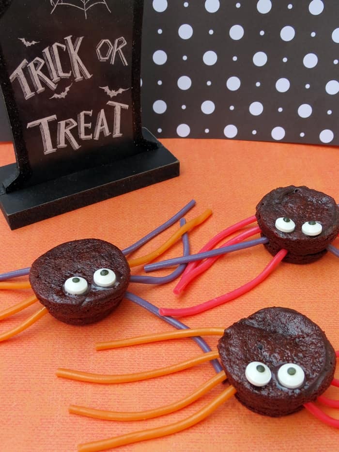 Brownie Bite spiders made with brownie bites, candy eyes, and licorice laces. 