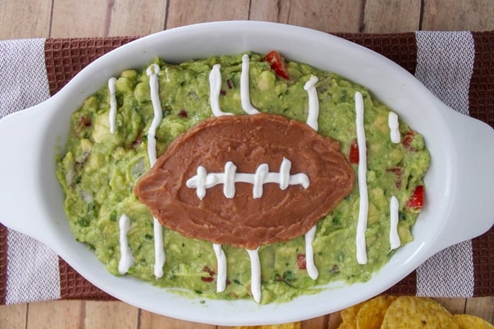 Homemade guacamole is a big game must have. This easy guacamole football recipe makes a perfect game day snack for the big game or any game!