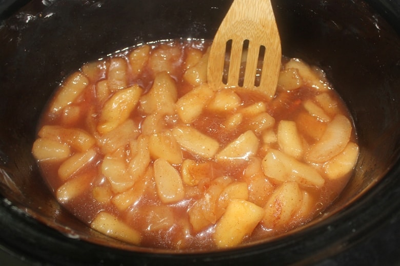 Stirring fried apples in the slow cooker