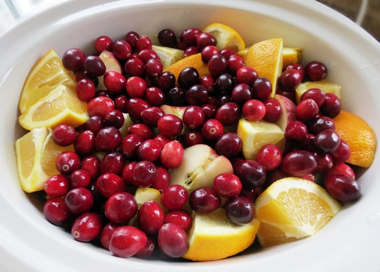 Cranberry apple cider made with sweet tea is an amazing twist on typical hot apple cider, and is easy to make at home in your crockpot or slow cooker.