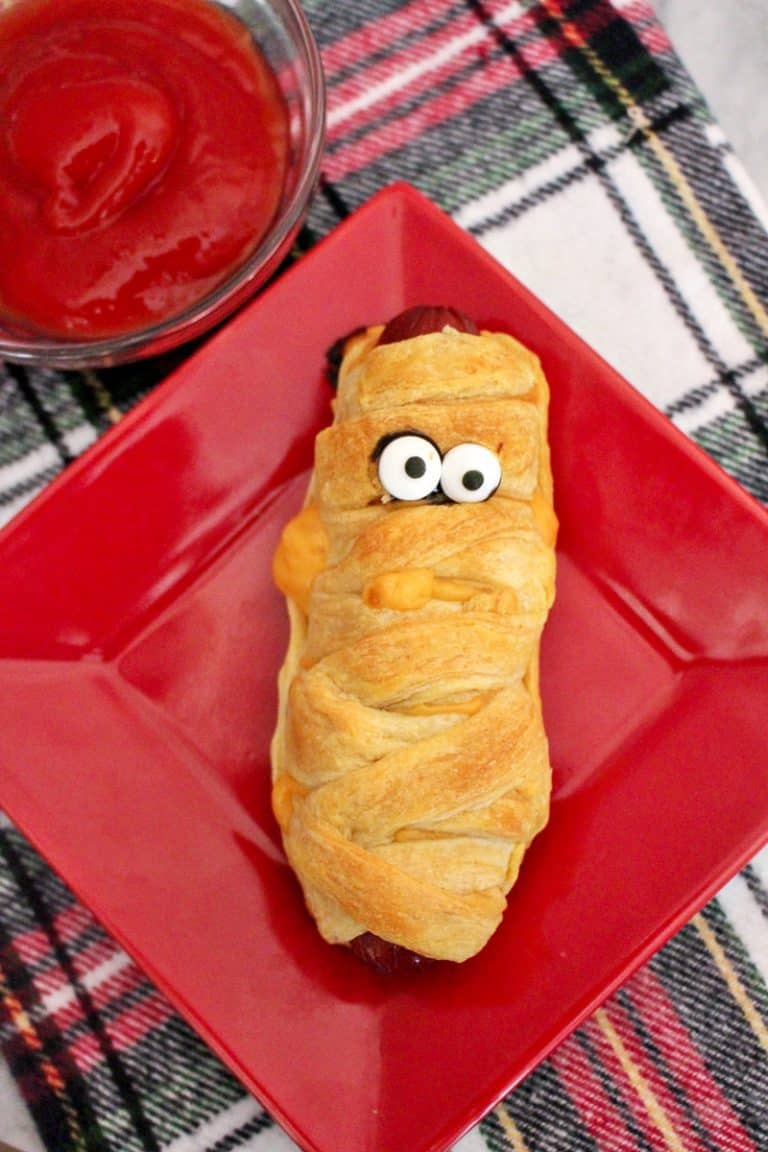 Mummy hot dogs are a fun #Halloween dinner, perfect after a busy night of trick-or-treating. Plus, they are ridiculously easy to make using crescent rolls. #HalloweenRecipes