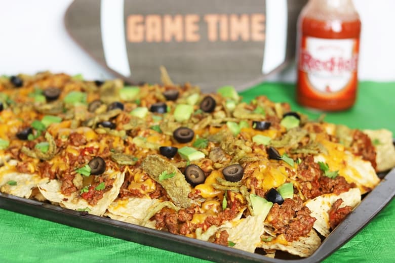 An easy loaded nachos recipe made in the oven. These baked nachos are packed with ground beef, cheddar cheese, and FRENCH'S™ Crispy Jalapeños.