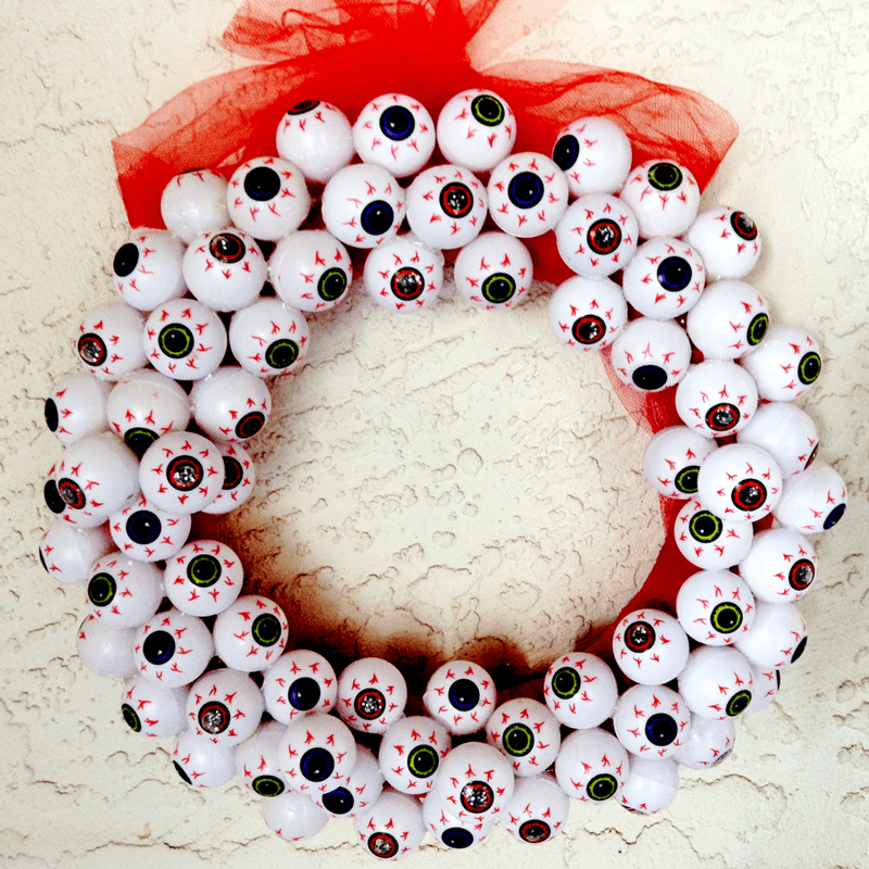 Add a little bit of Halloween flair to your front door with this easy-to-make "always watching" creepy eyeball DIY Halloween wreath.