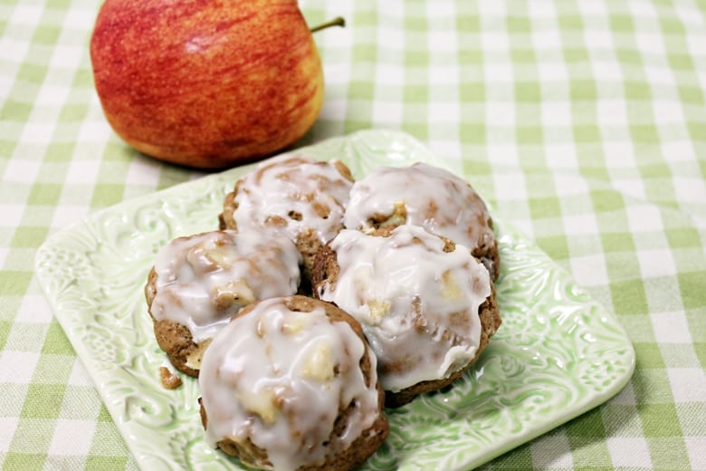 Soft apple cookies on a plate with apple in background