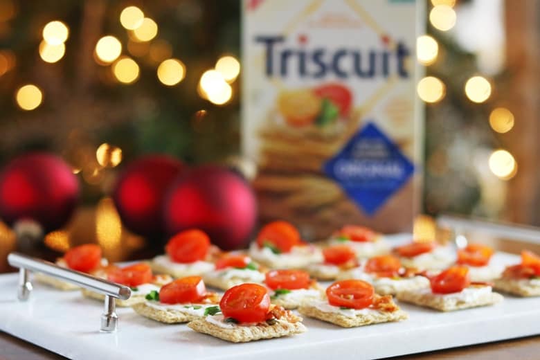 We top Triscuit crackers with cream cheese, bacon, and tomato for a quick and easy holiday appetizer. 