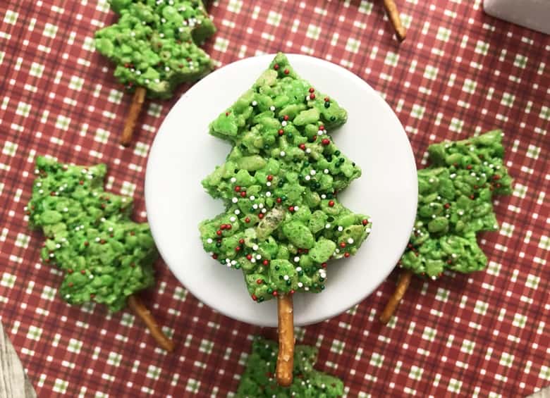 These easy-to-make, no bake, green Christmas Tree Rice Krispie Treats are sure to be the hit of the dessert table this Christmas– especially with the kids!