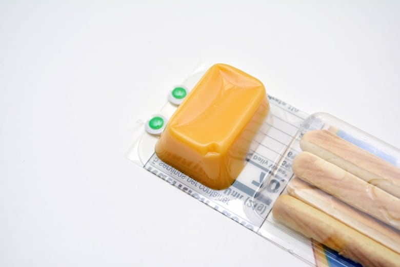 Glue eyes on bottom of cheese snacks