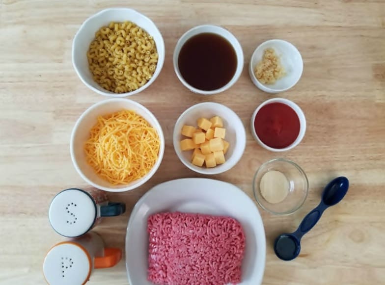 Cheesy Hamburger Casserole Ingredients: lean ground beef, pasta, cheddar cheese, American cheese, tomato puree, beef broth, olive oil, garlic, onion powder, salt and pepper. 