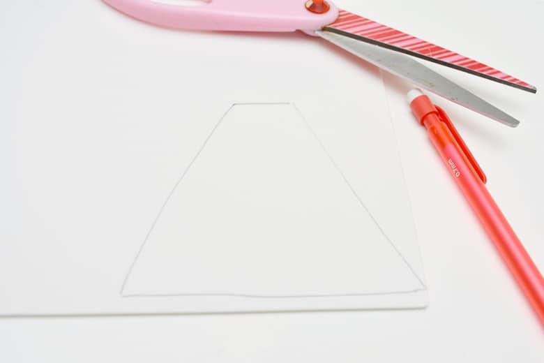 Cut a large white triangle with a flattened top out of the white craft foam.