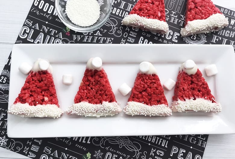 Santa Hat Rice Krispie Treats are easy to make for the kids this Christmas using a traditional Rice Krispies Treat recipe and just adding a few decorations!