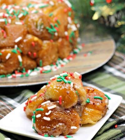 Made using refrigerated biscuit dough, stuffed with chocolate, and covered in holiday sprinkles this easy monkey bread recipe is a perfect treat for Christmas morning.