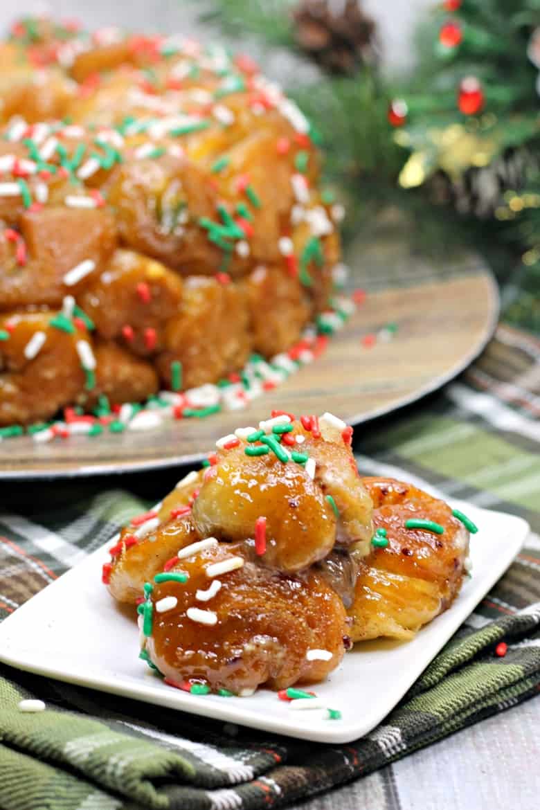 Made using refrigerated biscuit dough, stuffed with chocolate, and covered in holiday sprinkles this easy monkey bread recipe is a perfect treat for Christmas morning.