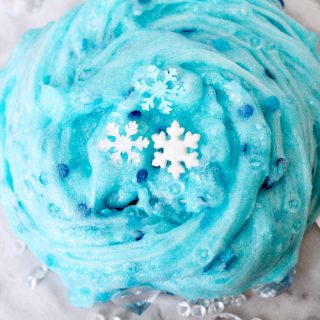 An easy Frozen slime recipe that Elsa would approve of! This glittery snowflake slime makes for a great Winter sensory play activity.