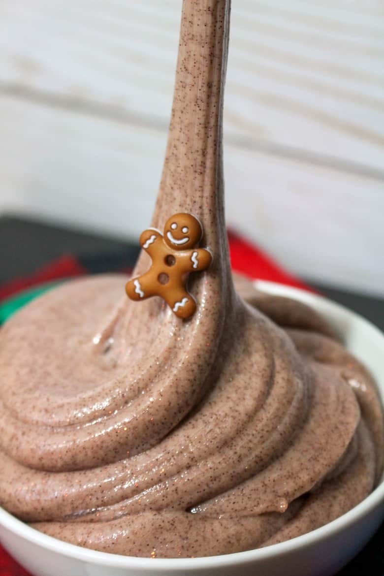 Glittery gingerbread slime being pulled out of bowl.
