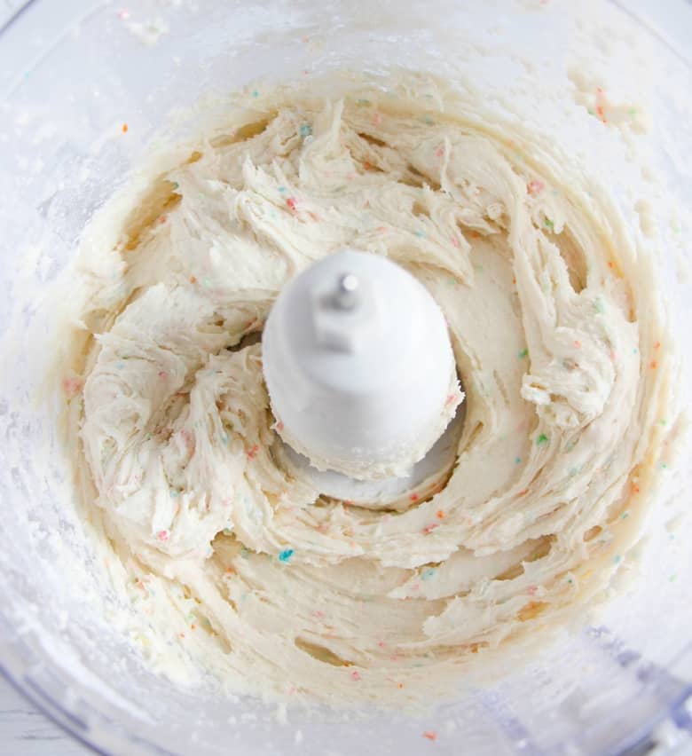 Blended cake batter dip ingredients in a food processor.