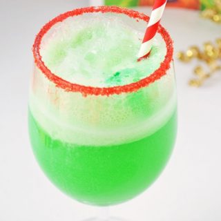 This small-batch Grinch Punch recipe made with Hawaiian Punch, Sprite and lime sherbet is a perfect drink for the kids on Christmas.