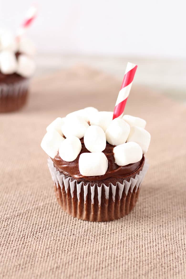 Turn a boxed Devil's Food Cake Mix, store bought icing, and mini marshmallows into fun hot chocolate cupcakes with this easy recipe.