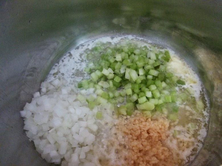 Diced veggies and oil in a pressure cooker