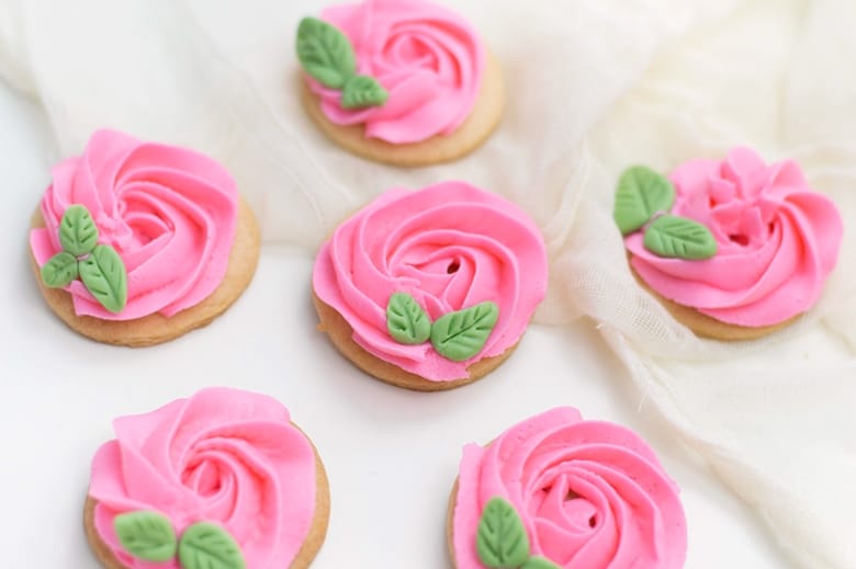 Learn how to decorate rose cookies using fondant and homemade buttercream icing. These beautiful pink rose sugar cookies are great for weddings, showers, or Valentine's Day.