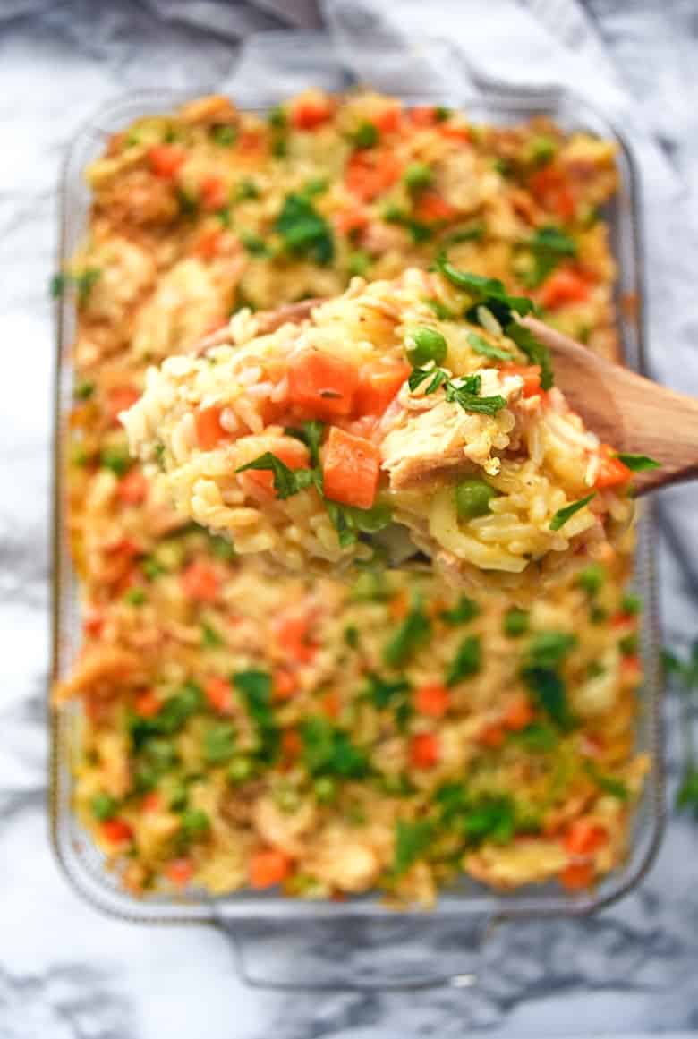 An incredible creamy chicken and rice casserole recipe made with frozen peas and carrots and cream of chicken soup.