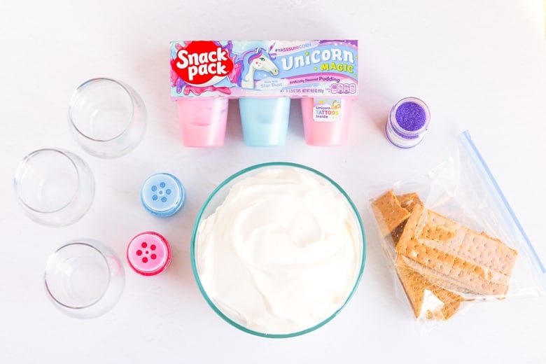 Unicorn Magic Parfait Ingredients: Unicorn Pudding Snack Packs, whipped topping, graham crackers in ziplock bag, sprinkles, and 3 cups