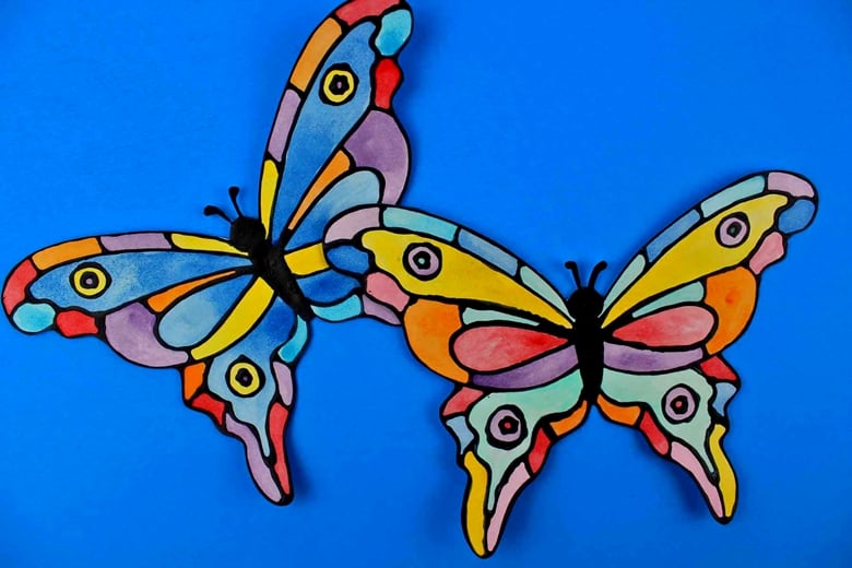 How to make a faux stained-glass butterfly craft using cardstock, glue, watercolors, and the provided printable butterfly template.