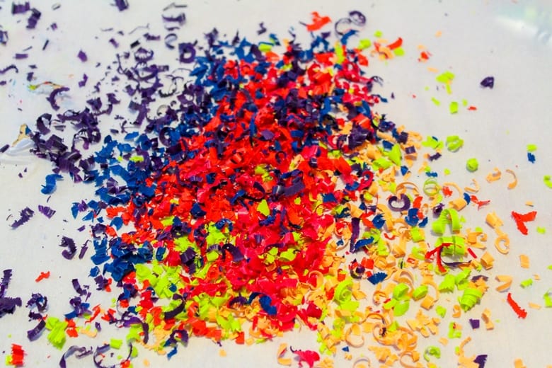 colorful crayon shavings on top of wax paper