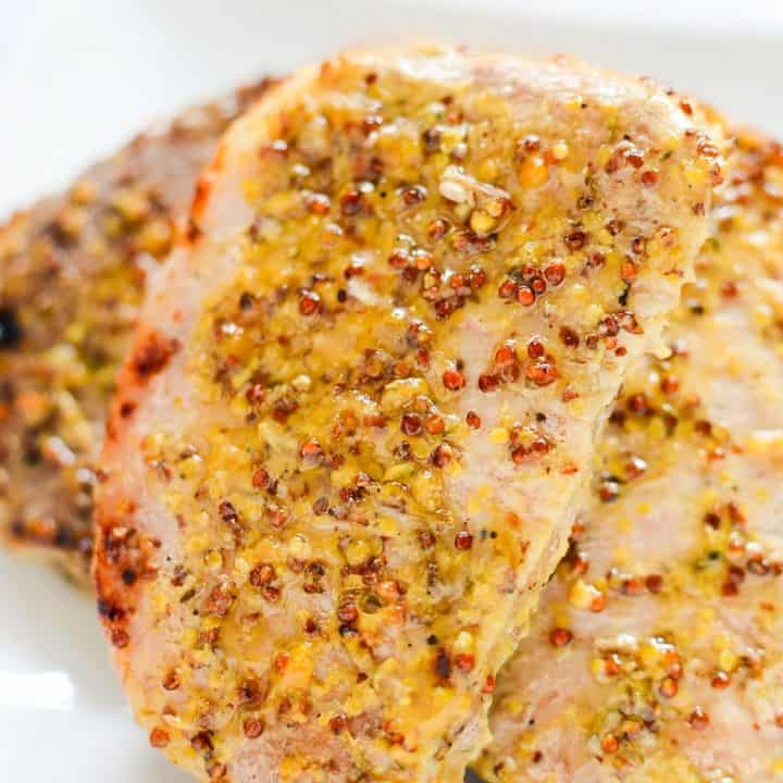 Juicy oven roasted pork chops with a delicious honey and grainy mustard sauce. This easy honey mustard pork chop recipe gets dinner on the table in under 40 minutes!